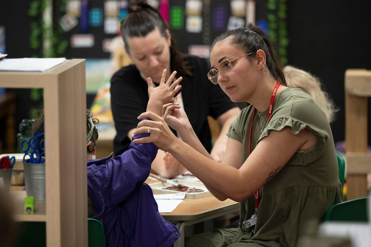 Teacher painting with a school pupil